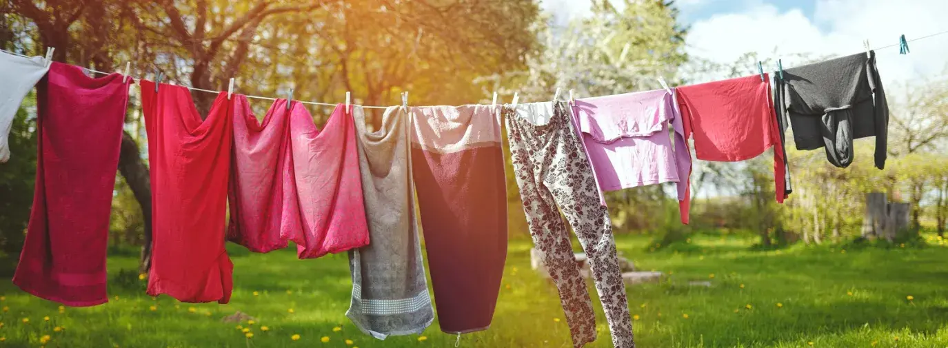 clothes on clothesline in green field 