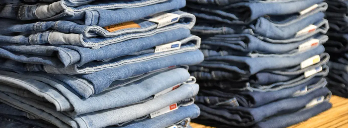 two stacks of light wash blue jeans