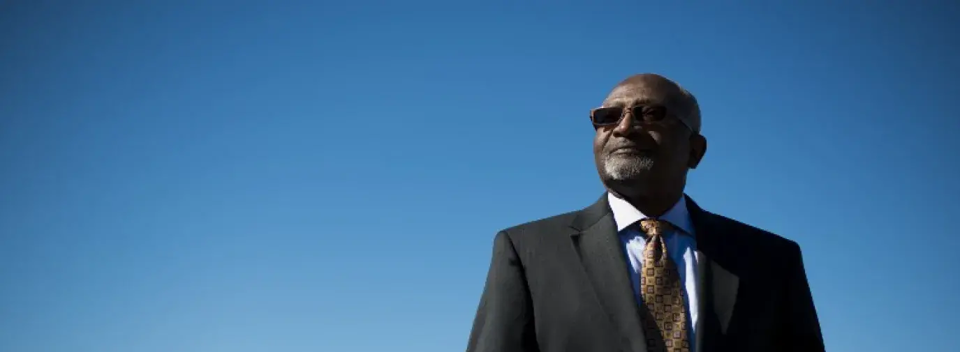 Image: Robert Bullard, black man standing in suit with blue sky in background. Topic: 8 Black Leaders Who've Revolutionized the Climate Movement