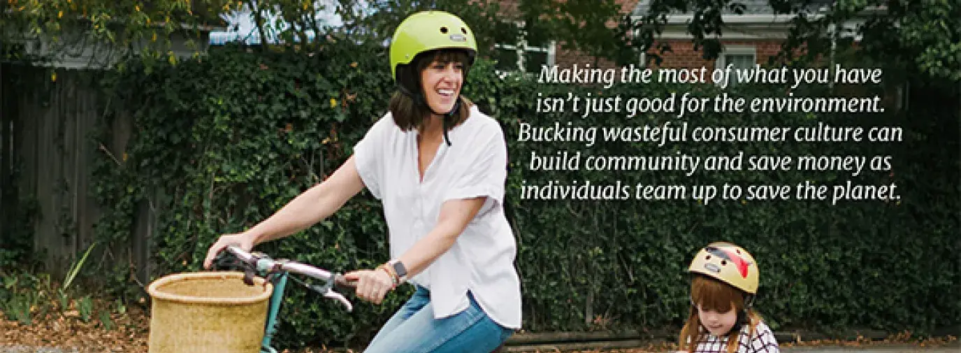 Consume less cover, mother biking on street with child in the back