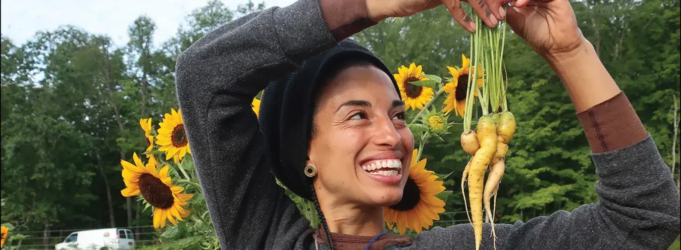 climate communities cover, woman holding crops