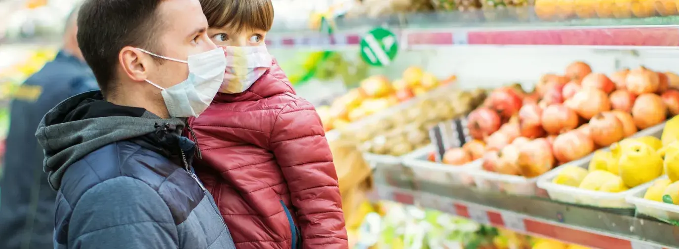 Image: masked parent holding child in supermarket. Title: "Don't Discount Our Future" Campaign Targets Trader Joe's Cocoa Sourcing and Climate-Damaging Refrigeration