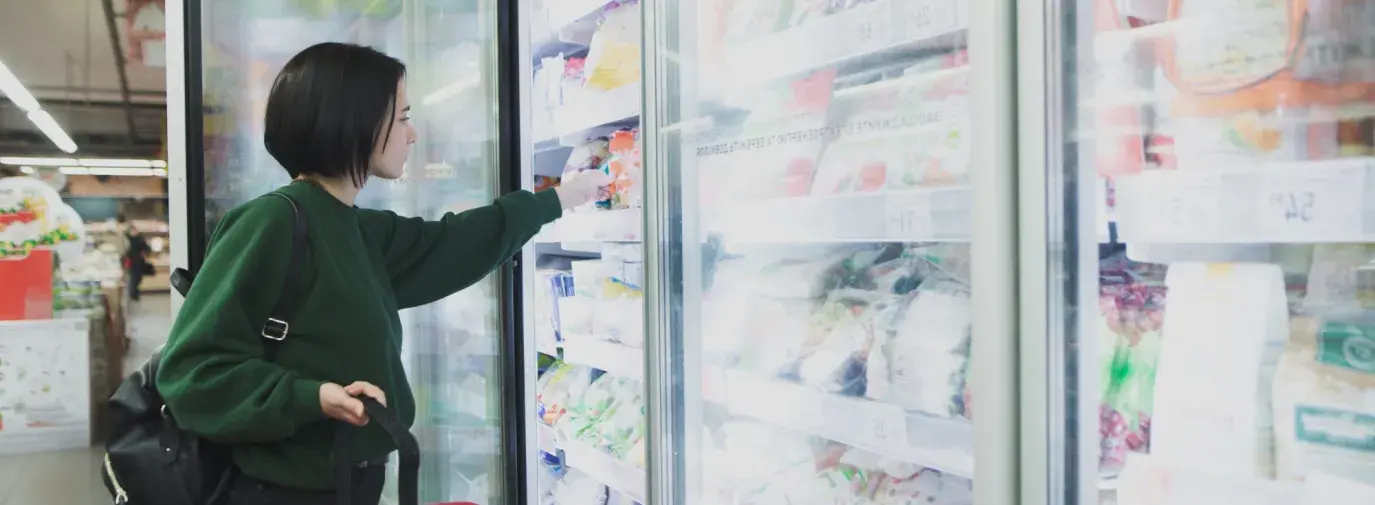 Image: shopper standing in front of supermarket coolers. Topic: Cool It for Climate
