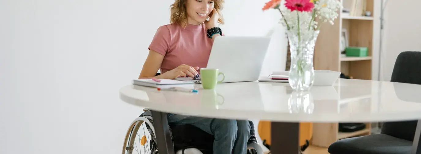 woman in wheelchair at table