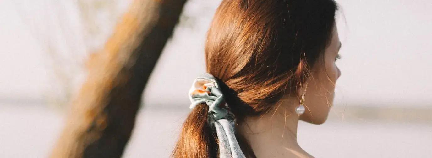 white woman wearing a head scarf in her hair