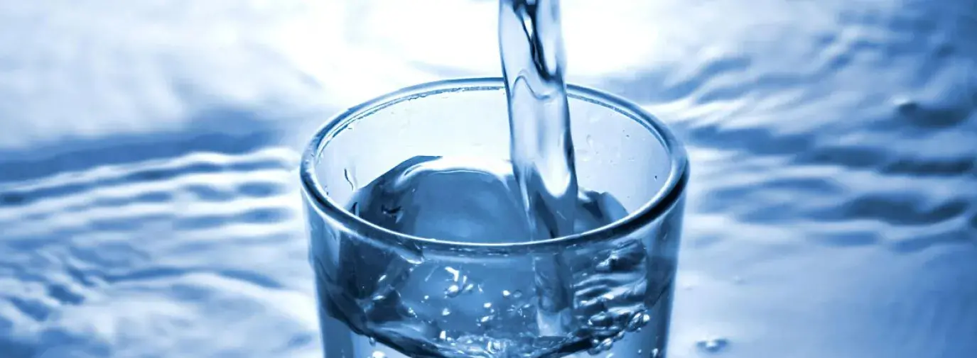 abstract photo of water being poured into a clear glass