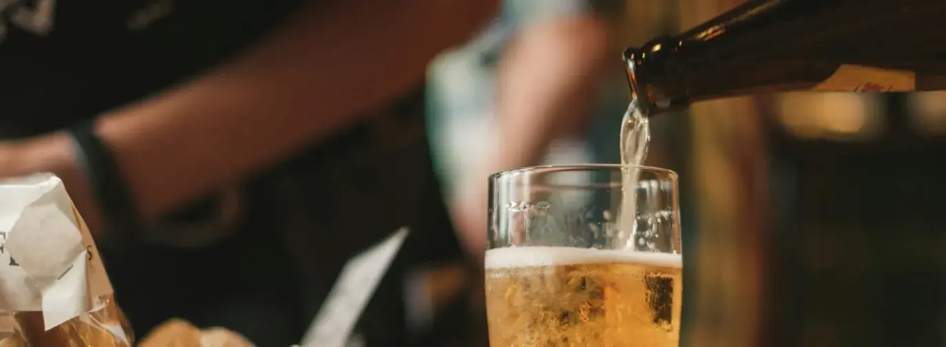 beer being poured into a cold pint glass. 