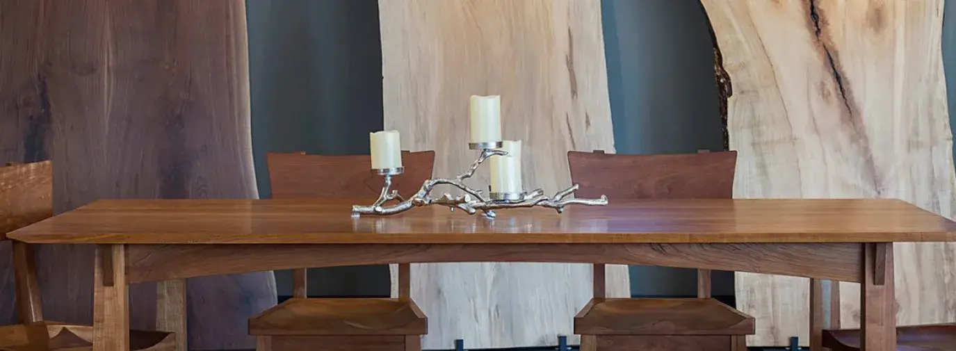 TY Fine Furniture table in front of wood slabs
