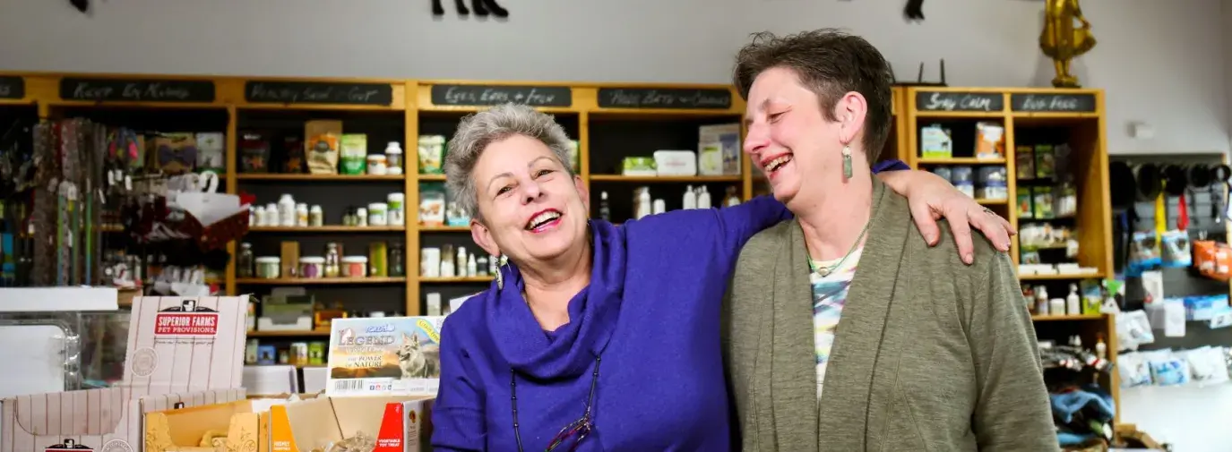 Julie Paez and Pennye Jones-Napier in their store, the Big Bad Woof, laughing