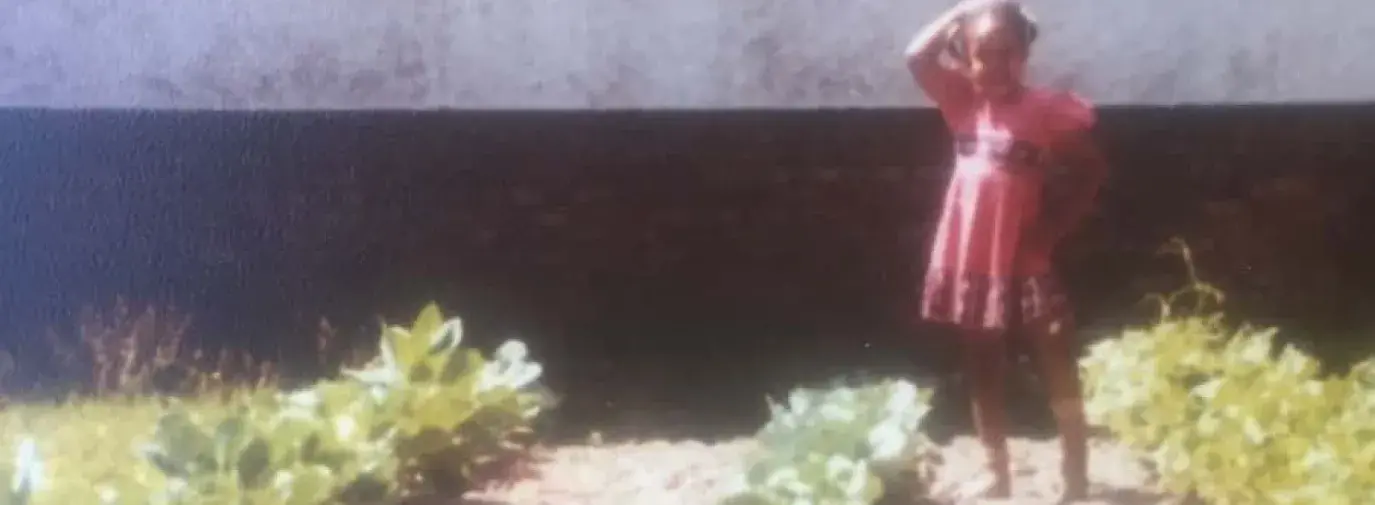 vintage photo of young girl in large urban garden