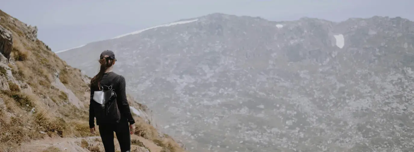 woman climbing a mountain