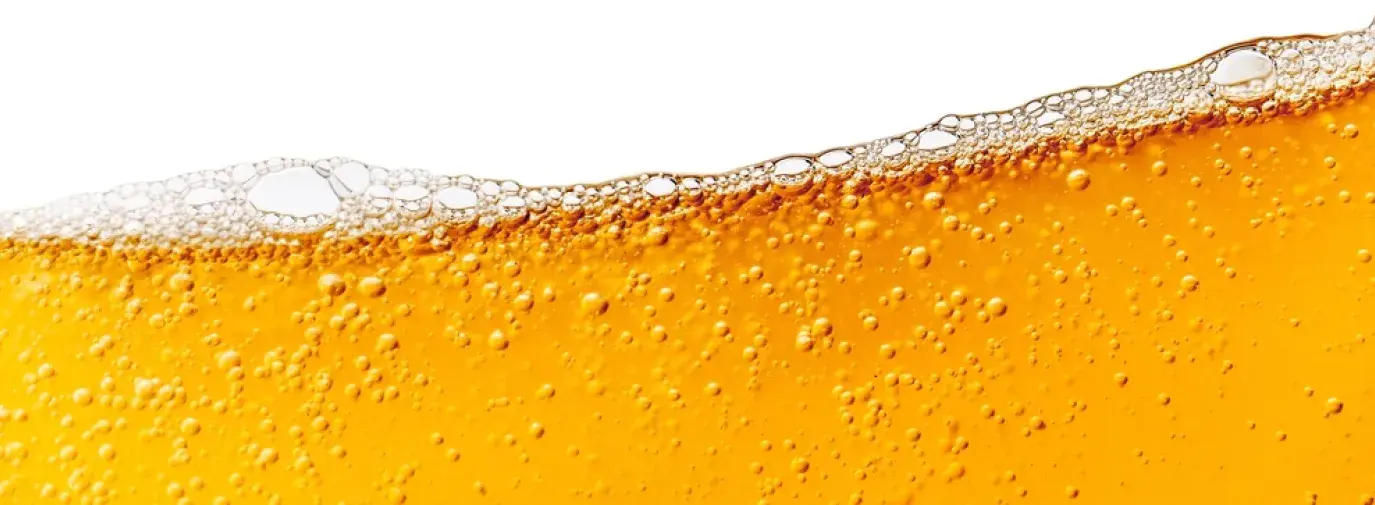 top of a glass of golden beer