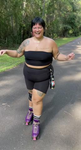Eileen Pagan wearing a black tube top and bike shorts while roller skating on the rail trails of Atlanta