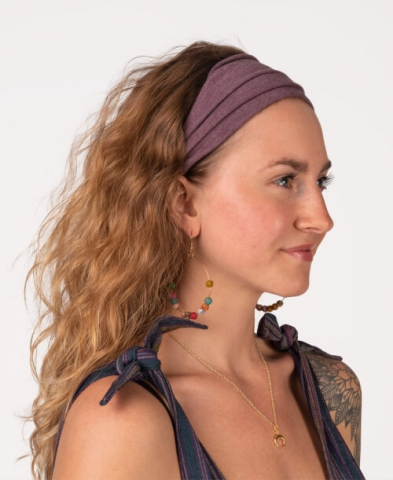 White woman wearing a soft headband in plum. Sustainable Halloween Costumes.