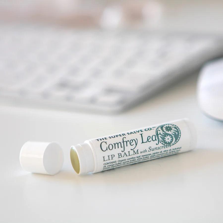 An open lip balm laying on a table. Sustainable summer.