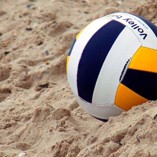 Volleyball in natural sand. Sustainable summer.