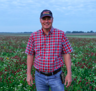 Image: Indiana farmer Rick Clark in field of crimson and balansa clover cover crops.