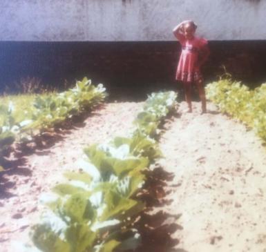vintage photo of young girl in large urban garden
