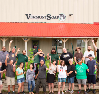 Group of individuals standing in front of a Vermont Soap factory