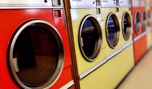 Image: colorful dryers in a laundramat. Topic:5 Reasons to Ditch your Clothes Dryer
