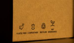 A compostable cardboard box with various certifications