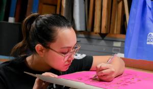 A woman stenciling 