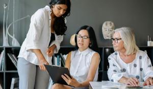 Three women looking at financial information