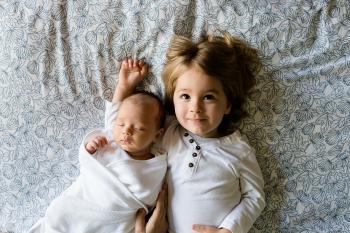 Image: two kids lie on a bed. Title: Eco-Friendly Children's Clothing